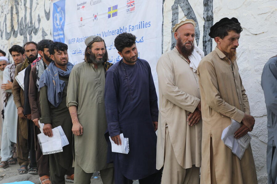 Men wearing traditional clothes line up for WFP assistance in earthquake-hit eastern Afghanistan. Photo: WFP/Arete/Muktar Nikrawa 